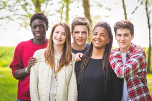 Teenagers smiling for a photograph while learning about how to talk to teens about gambling